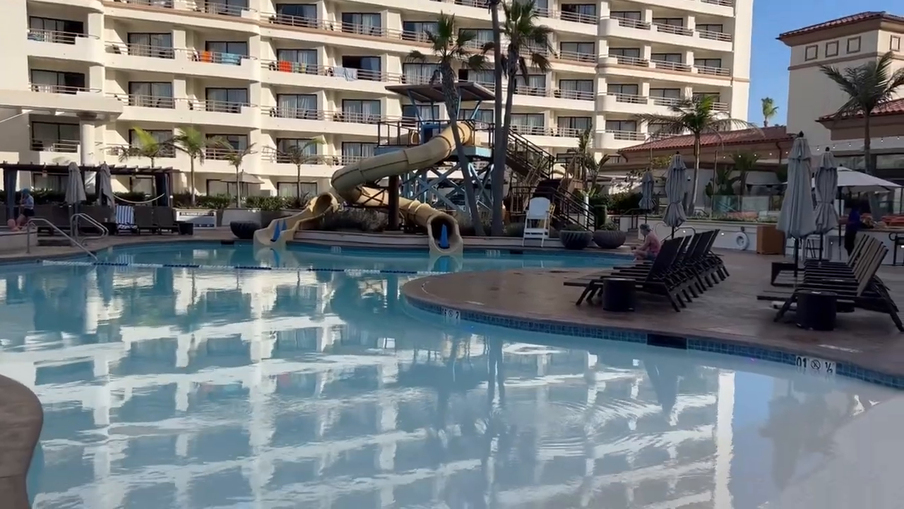 The family pool at the Waterfront Beach Resort with water slides and lounge chairs. 